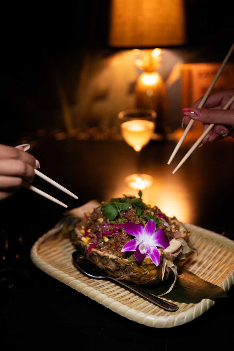 Pineapple bowl dish with orchid garnish